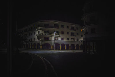 Illuminated street and buildings in city at night