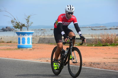 Full length of woman riding bicycle