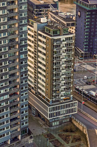 Aerial view of an office and residential building from the 1950's, now dwarfed by talled skyscrapers