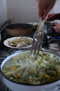 Close-up of person preparing food in kitchen