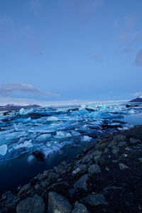 Scenic view of frozen lake against sky