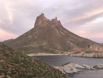 Scenic view of lake and mountains against sky
