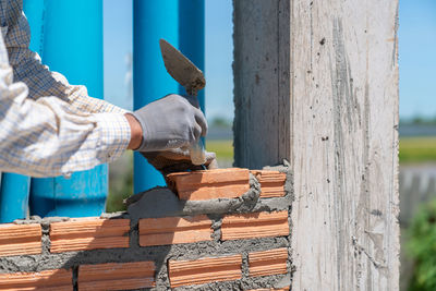 Cropped hand of man cutting wood