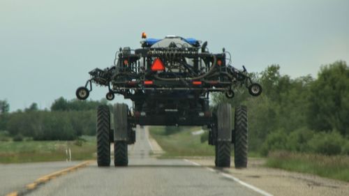 View of tractor on landscape against sky