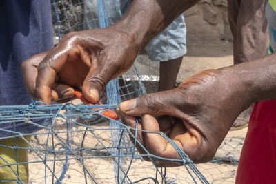 Cropped hand of fisherman holding fishing net