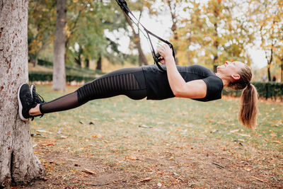 Full length of woman exercising in park