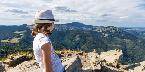 Side view of woman looking at mountains
