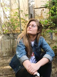 Portrait of young woman sitting outdoors