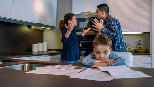 Full length of father and son on table