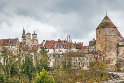 Buildings against cloudy sky