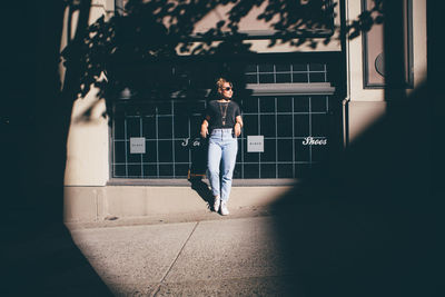 Full length of woman using mobile phone