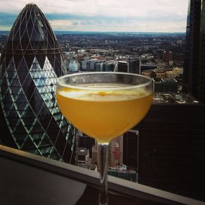 Close-up of beer in glass against cityscape