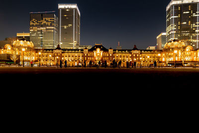 Illuminated city buildings at night