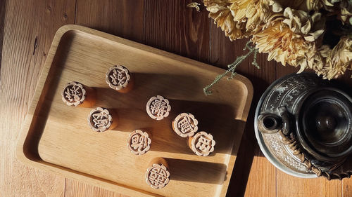 Tea cup with wooden alphabet stamp set on table, tea on table