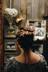 Rear view of woman standing against wall