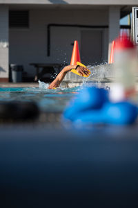 Cropped hand in swimming pool