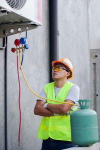 Worker looking at pressure gauges at construction site