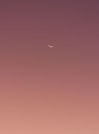 Low angle view of moon against sky at sunset