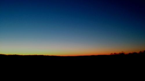 Scenic view of silhouette landscape against clear sky at sunset