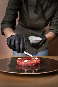 Midsection of man preparing food on table