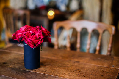 Close-up of red rose flower vase on table
