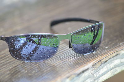 Close-up of sunglasses on glass table