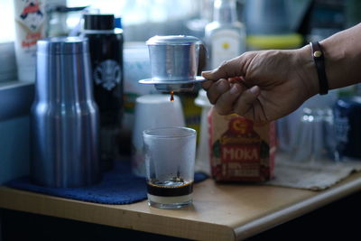 Midsection of coffee cup on table