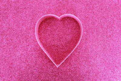 Close-up of heart shape on pink fabric