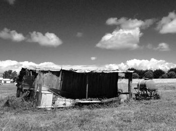 Built structure on field against cloudy sky