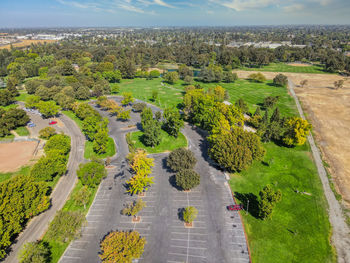 High angle view of road amidst trees against sky