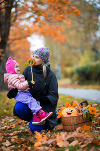 Close-up of boy with basket in park during autumn