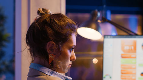 Side view of young woman looking away