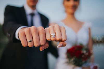 Midsection of couple holding hands