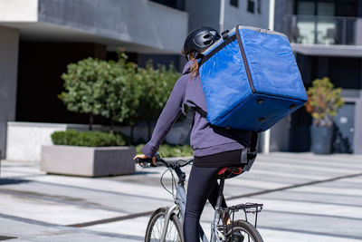 Delivery person riding bicycle in the city