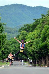 Man jumping on road during marathon