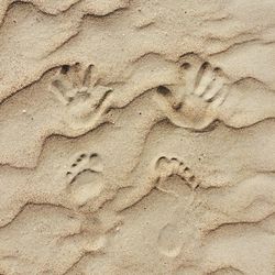 High angle view of footprints on sand at beach