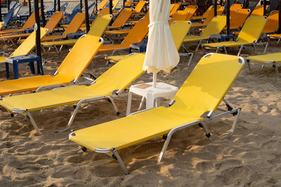 Rows of yellow empty beach beds.