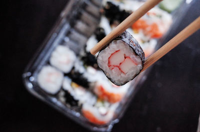 Close-up of chopsticks with sushi