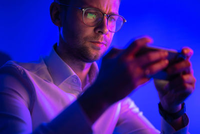 Side view of man using mobile phone