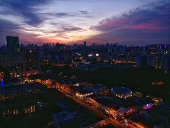 High angle view of city lit up at night