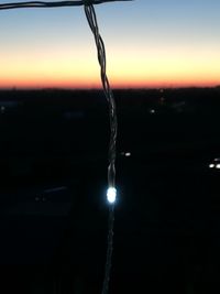 Close-up of icicles against sky during sunset