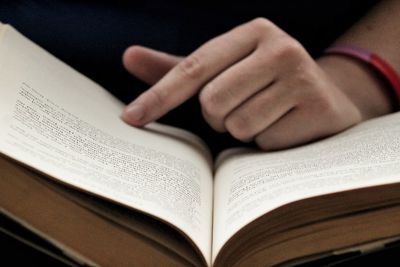 Close-up of hand on book