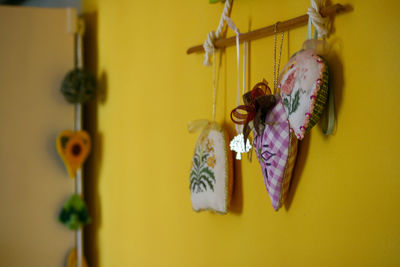 Close-up of yellow flowers hanging on wall