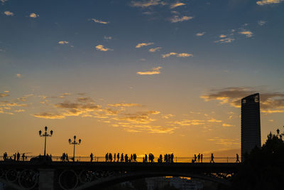 Illuminated bridge against sky during sunset