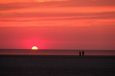 Scenic view of sea against orange sky