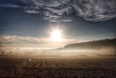 Scenic view of field against sky during sunset