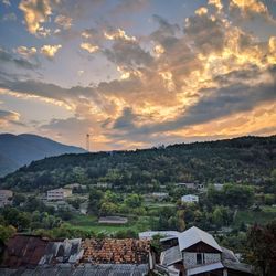 Townscape against sky during sunset