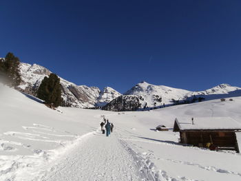 Rear view of person on snowcapped mountain road