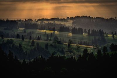 Scenic view of landscape against sky at sunset