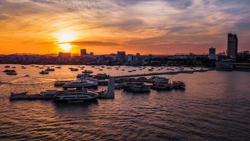 View of sea and buildings against sky during sunset